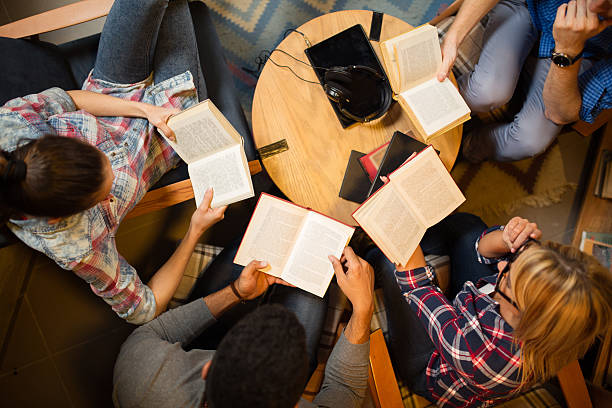 a group of people reading books