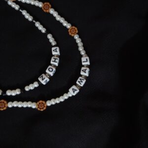 Custom pearl name necklace! Spell out your name or a special word with elegant faux pearls and floral accents. Unique and personalized jewelry.